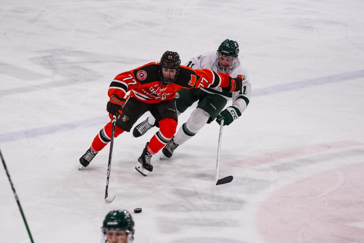 Bowling Green, OH - Falcons freshman forward Dominik Rymon (77) rushing the puck up the ice at Slater Family Ice Arena in Bowling Green, OH