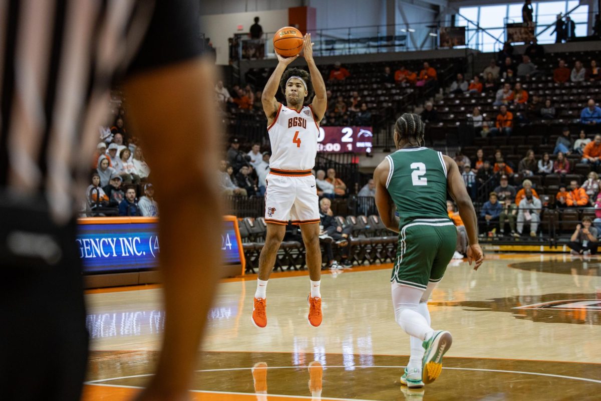 Bowling Green, OH - Falcons sophomore guard Josiah Shackelford (4) shoots for three at the Stroh Center in Bowling Green, Ohio.