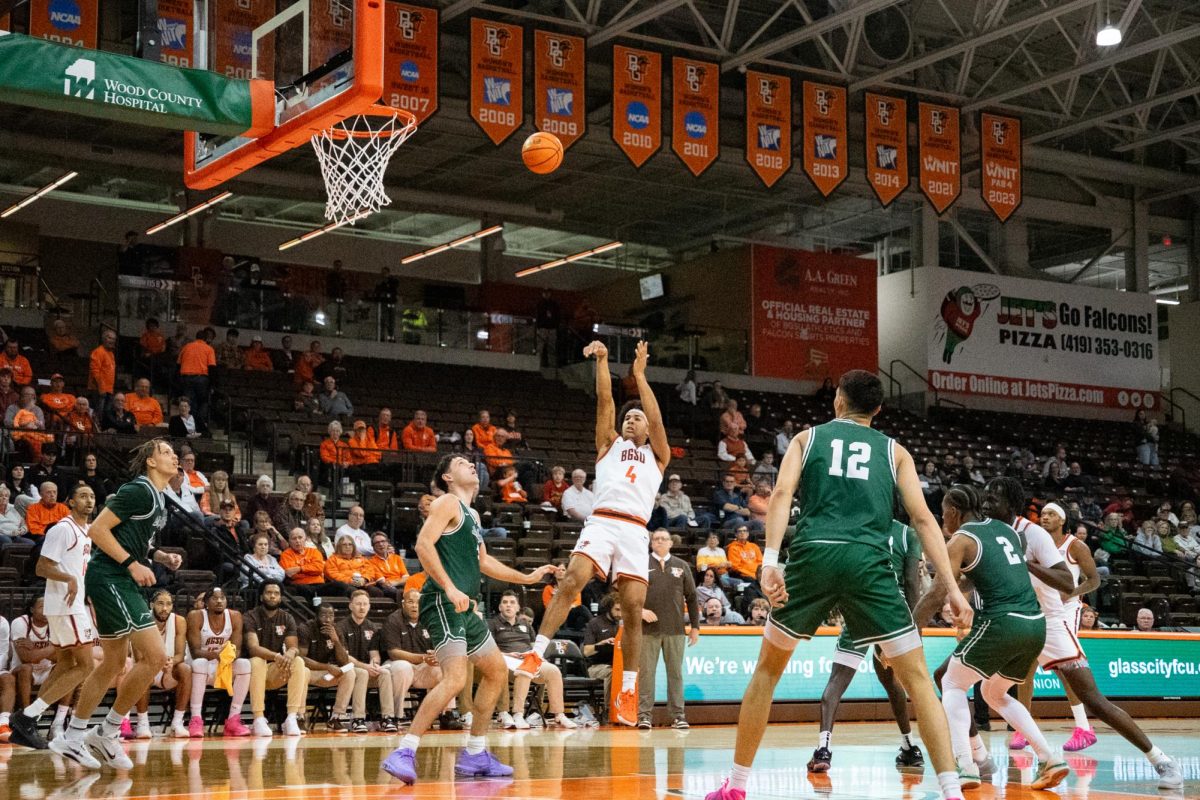 Bowling Green, OH - Falcons sophomore guard Josiah Shackelford (4) shoots a step back shot over a Dolphins defender at the Stroh Center in Bowling Green, Ohio.
