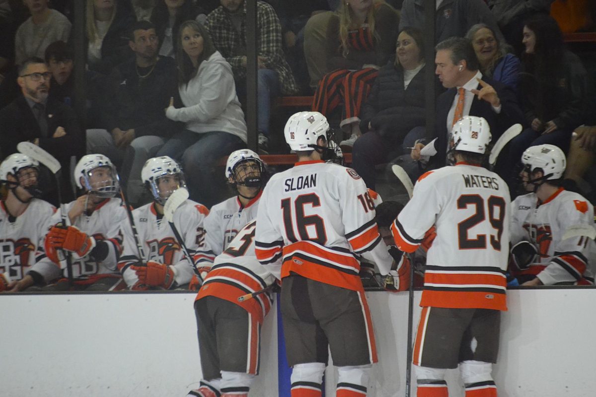 Bowling Green, OH - Falcons receiving a talk from Assistant Hockey Coach Matt Nicholson during a review of a goal at the Slater Family Ice Arena in Bowling Green, Ohio.
