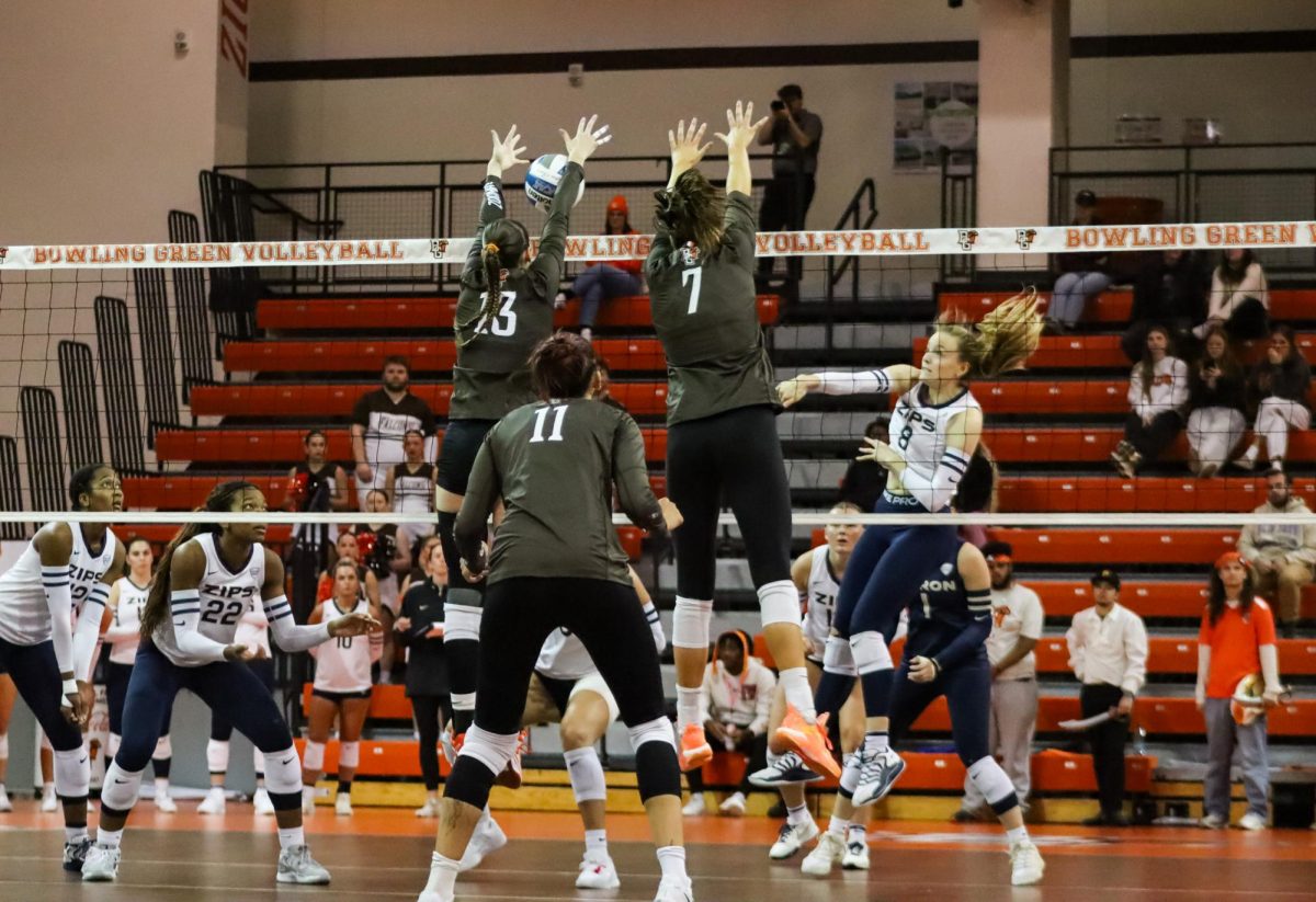 Bowling Green, OH - Falcons middle blockers freshman Kendall Williams (13) and senior Jessica Andrews (7) go up for a block at the Stroh Center in Bowling Green, Ohio.