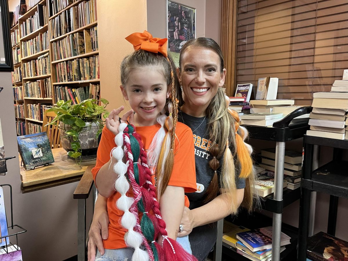 Elliete Cox (left) and Kristina Rogers (right) pose with a pony.