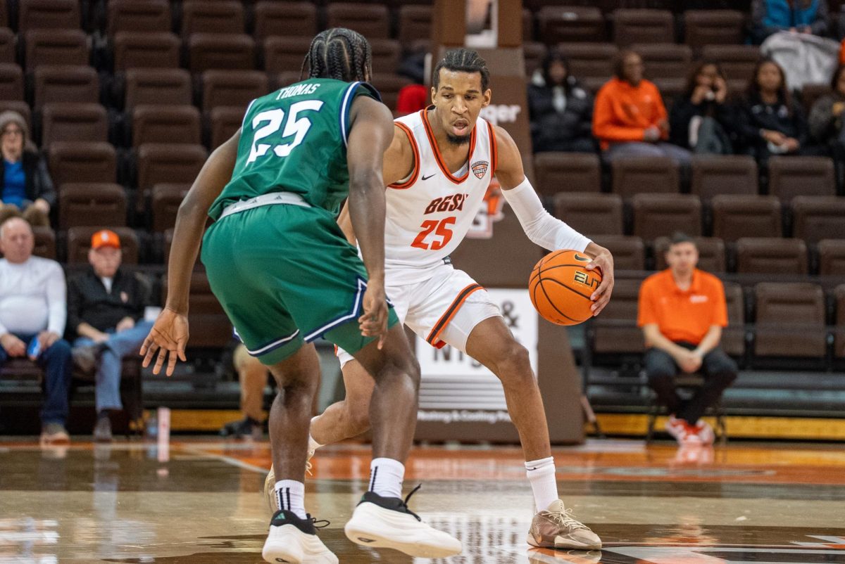 Bowling Green, OH - Falcons senior guard Justin Thomas (25) bring the ball up the court at the Stroh Center in Bowling Green, Ohio.