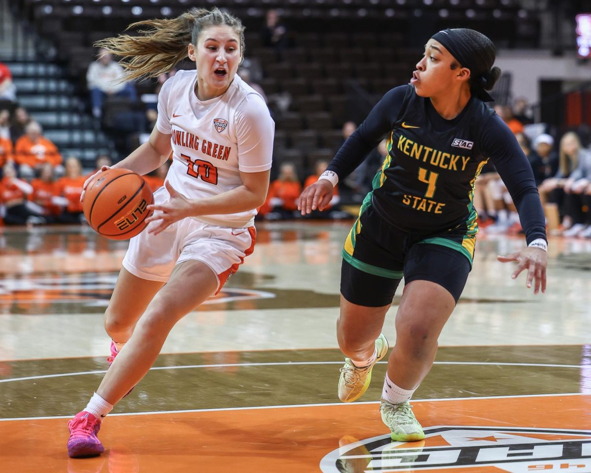 Bowling Green, OH - Falcons junior guard Paige Kohler (10) drives to the rim past Thorobreds senior guard Diara McBroom (4) during a game between the Kentucky State Thorobreds and the Bowling Green Falcons at the Stroh Center in Bowling Green, Ohio.