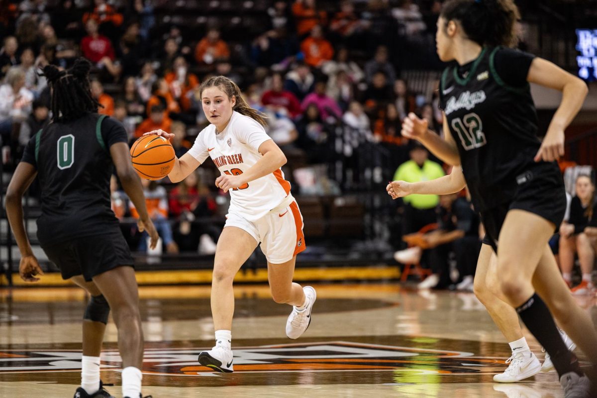 Bowling Green, OH - Falcons junior guard Paige Kohler (10) swims through a pack of Dolphins during a game between the Le Moyne Dolphins and the Bowling Green Falcons at the Stroh Center in Bowling Green, Ohio.