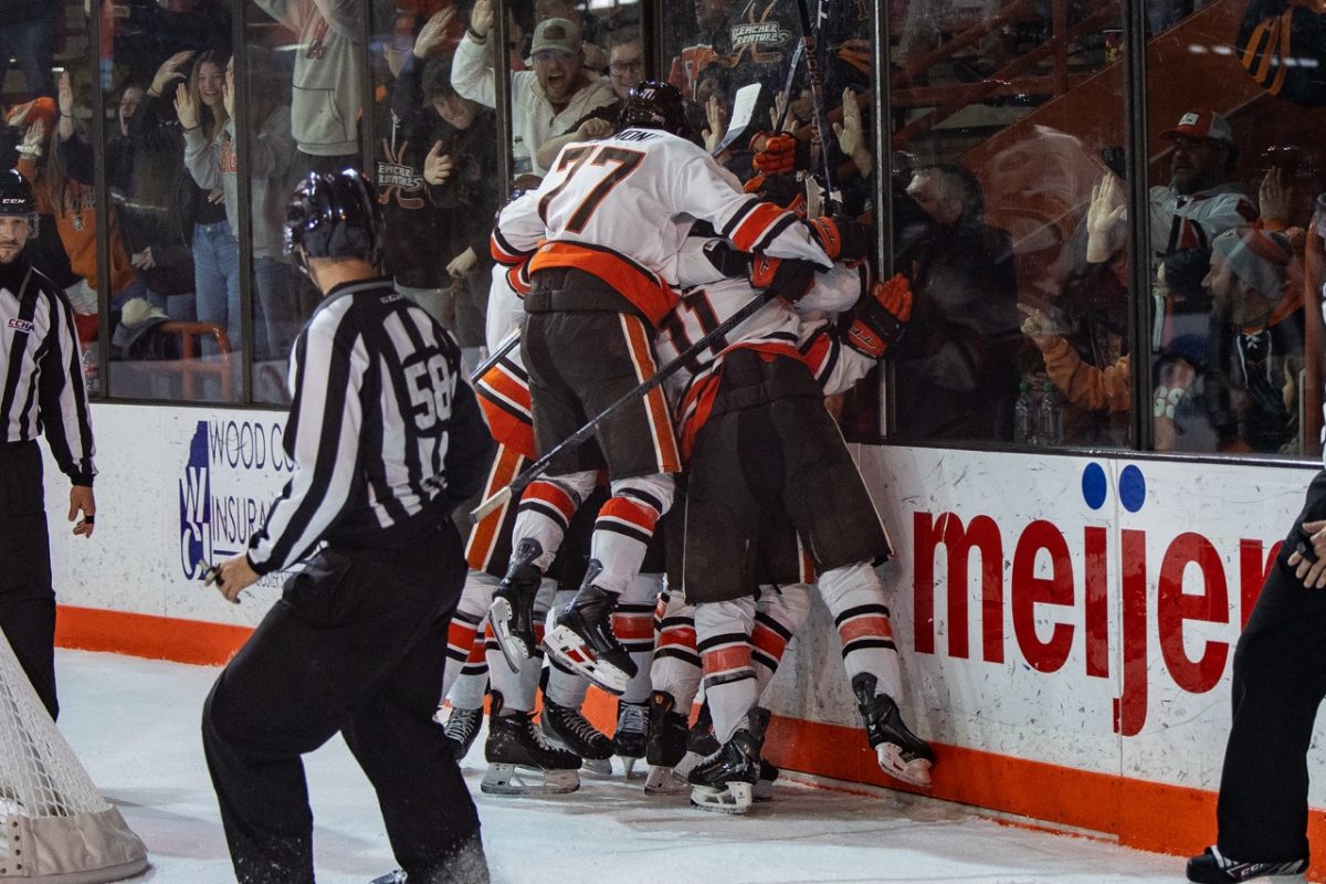 Bowling Green, OH - Members of the Falcons swarm after a goal during a game between the Northern Michigan Wildcats and the Bowling Green Falcons in Slater Family Ice Arena in Bowling Green, Ohio.