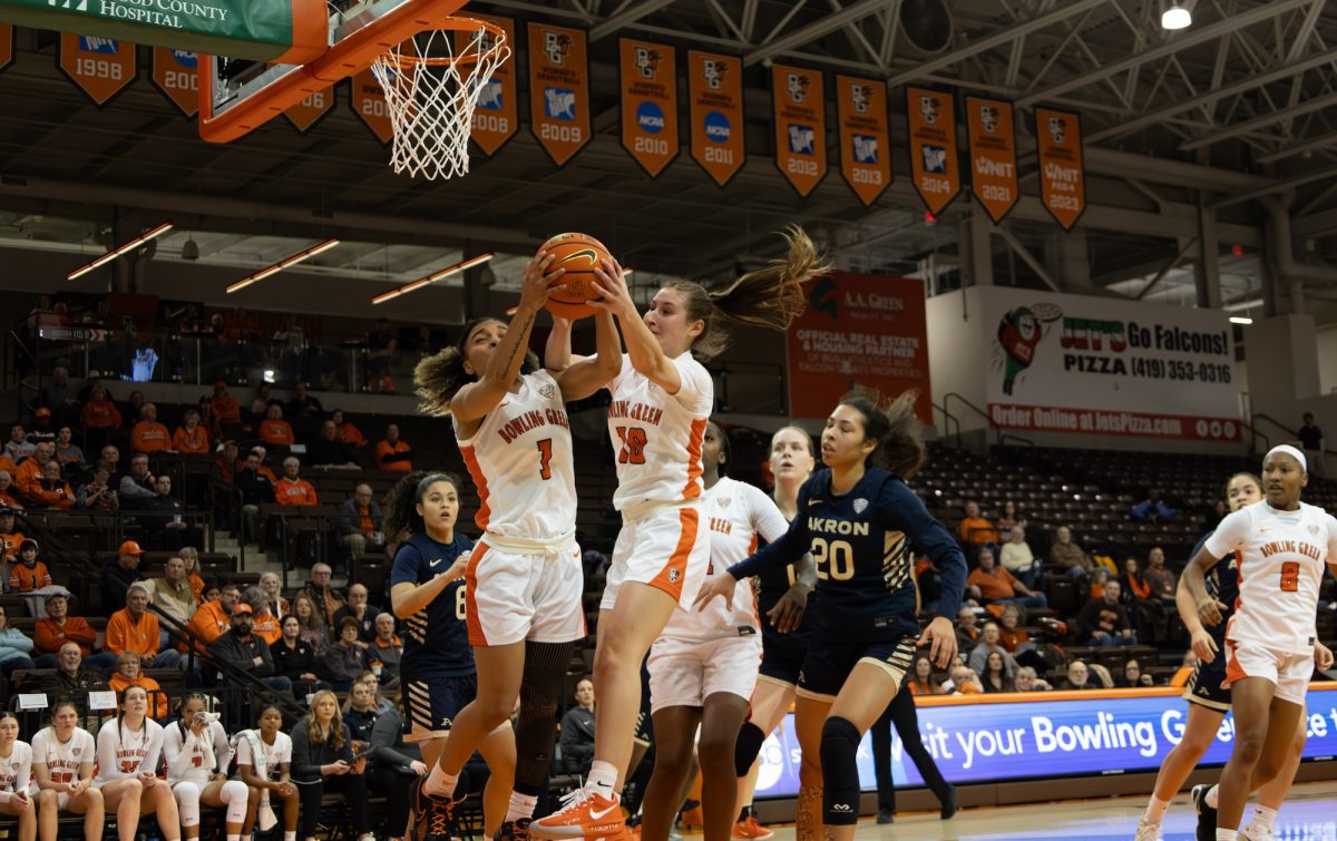 Bowling Green, OH - Falcon senior guard Kaia Woods (1) and junior guard Paige Kohler (10) rebounding the ball during a game between the Falcons and the Akron Zips at the Stroh Center in Bowling Green, Ohio.