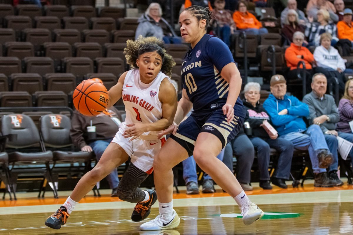 Bowling Green, OH - Falcons senior guard Kaia Woods (1) gets pressured by Zips freshman guard Corinne Reed (10) during a game between the Bowling Green Falcons and the Akron Zips at the Stroh Center in Bowling Green, Ohio.
