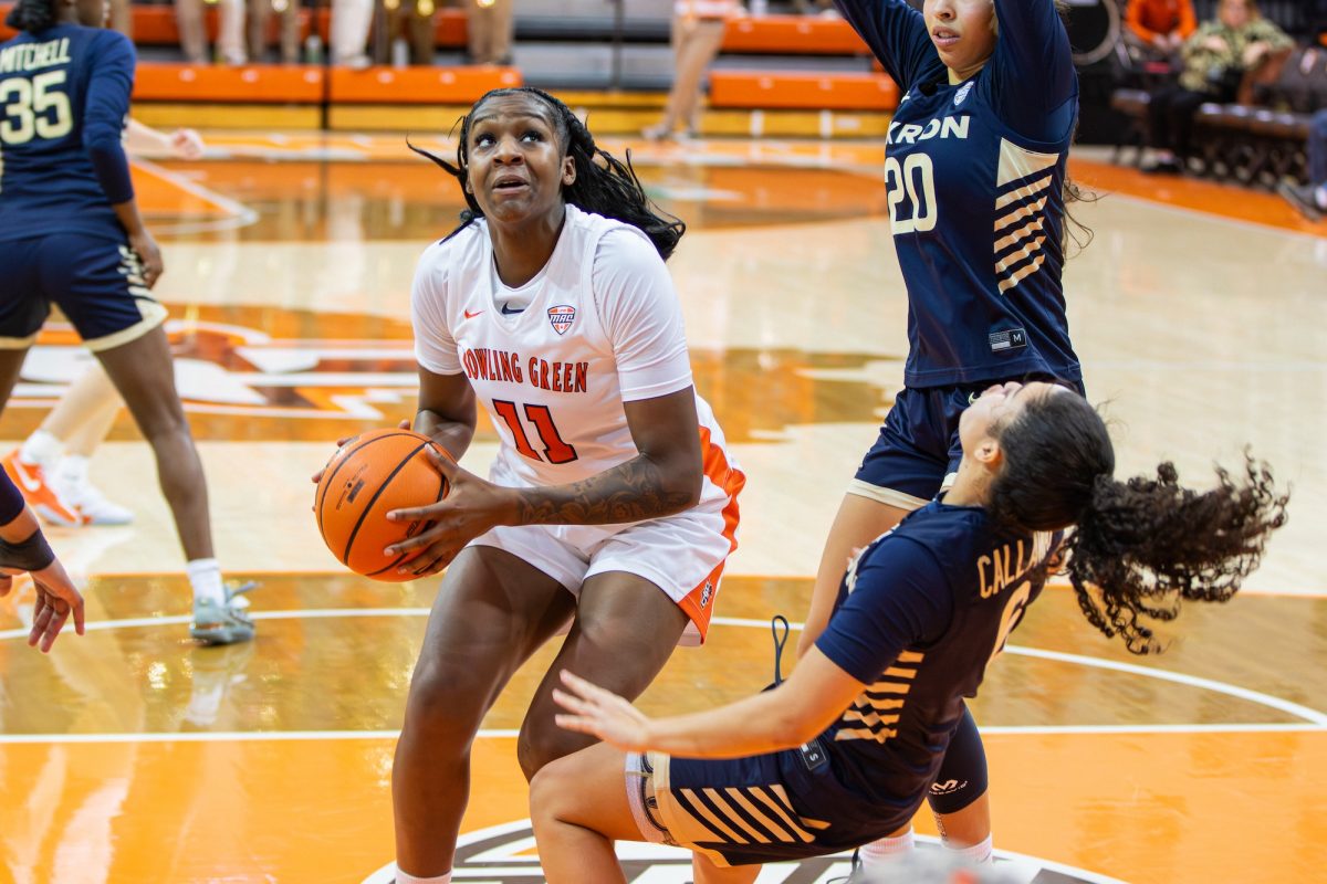 Bowling Green, OH - Zips sophomore guard Izzy Callaway (6) gets fouled by Falcons junior forward Taya Ellis (11) during a game between the Bowling Green Falcons and the Akron Zips at the Stroh Center in Bowling Green, Ohio.