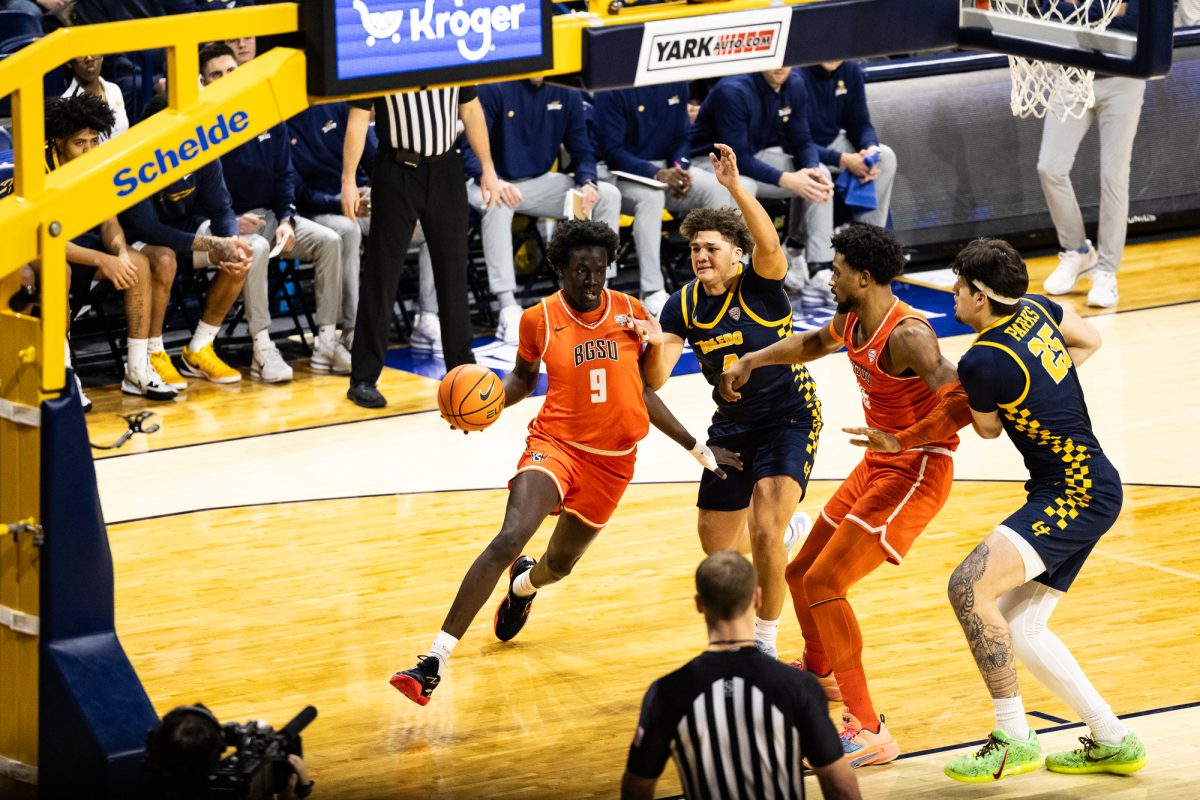 Toledo, OH - Falcons junior forward Mayar Wol (9) drives to the rim past Rockets senior guard Kyler Vanderjagt (4) during a game between the Bowling Green Falcons and the Toledo Rockets  at Savage Arena in Toledo, Ohio.