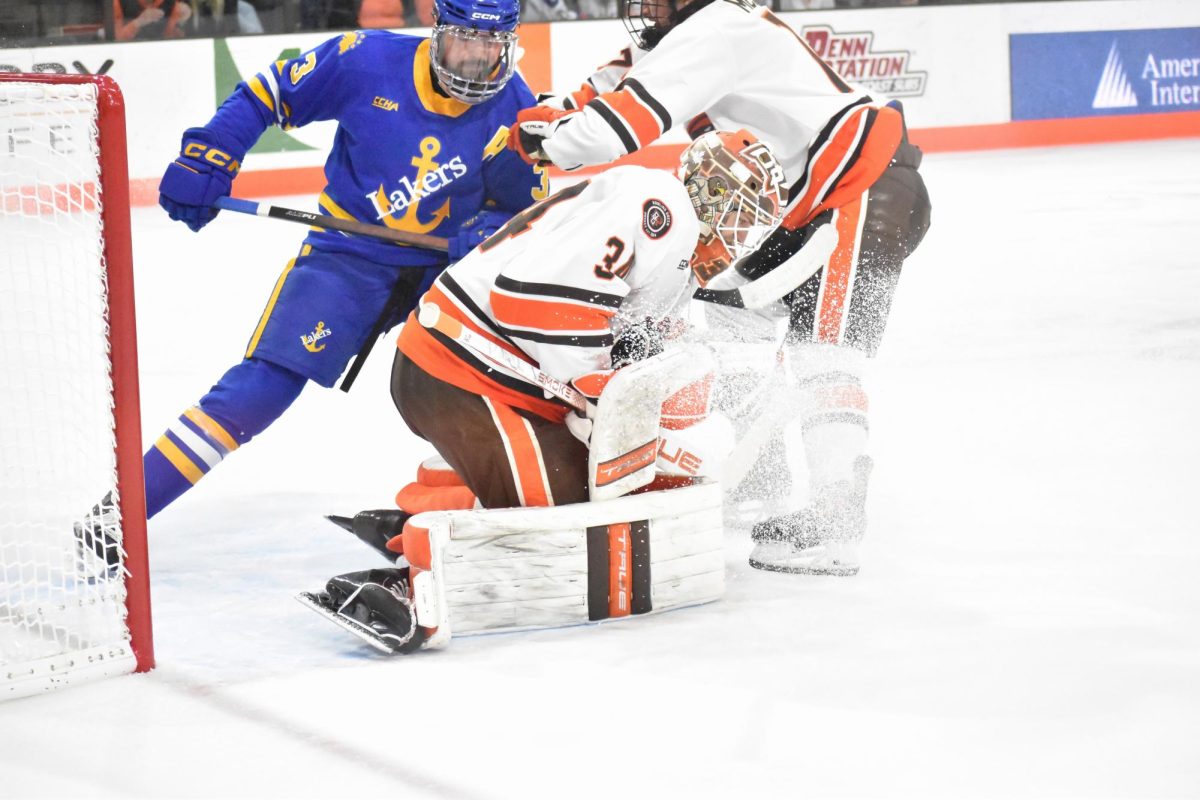 Bowling Green, OH - Falcons junior goalie Cole Moore (34) stops a shot during a match against Lake Superior State at Slater Family Ice Arena in Bowling Green, Ohio.