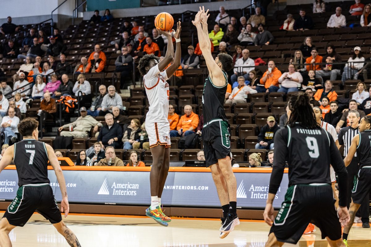 Bowling Green, OH - Falcons junior forward Mayar Wol (9) takes a shot over Eagles redshirt freshman forward Mohammad Habhab (4) during a game between the Eastern Michigan Eagles and the Bowling Green Falcons at the Stroh Center in Bowling Green, Ohio.