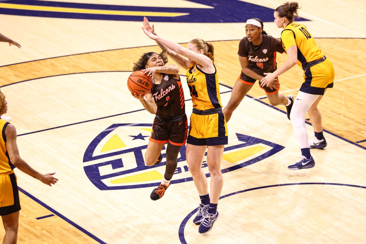 Toledo, OH - Falcons senior guard Kaia Woods (1) gets fouled on her way up to the basket at the John F. Savage Arena in Toledo, Ohio.