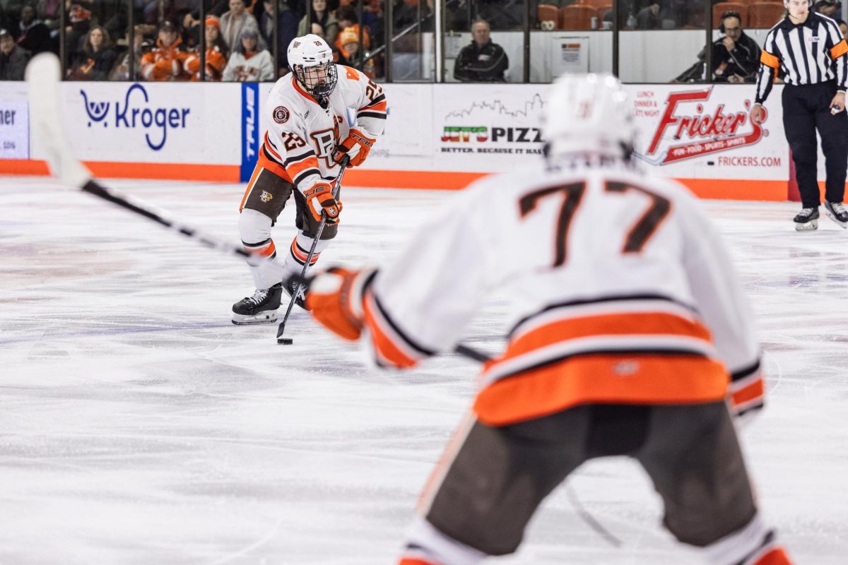  Bowling Green, OH - Falcons freshman forward Brayden Crampton (25) looks to pass to Falcons freshman forward Dominik Ramon (77)  during a game between the Lake Superior State Lakers and the Bowling Green Falcons in Bowling Green, Ohio.