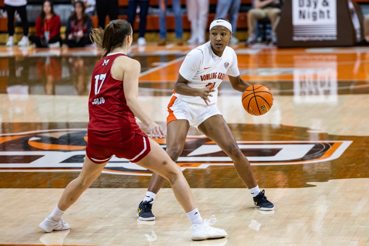 Bowling Green, OH - Falcons junior forward Joniyah Bland-Fitzpatrick (8) looks to pass past Redhawks junior guard Núria Jurjo (17) during a game between the Miami Redhawks and the Bowling Green Falcons at the Stroh Center in Bowling Green, Ohio.