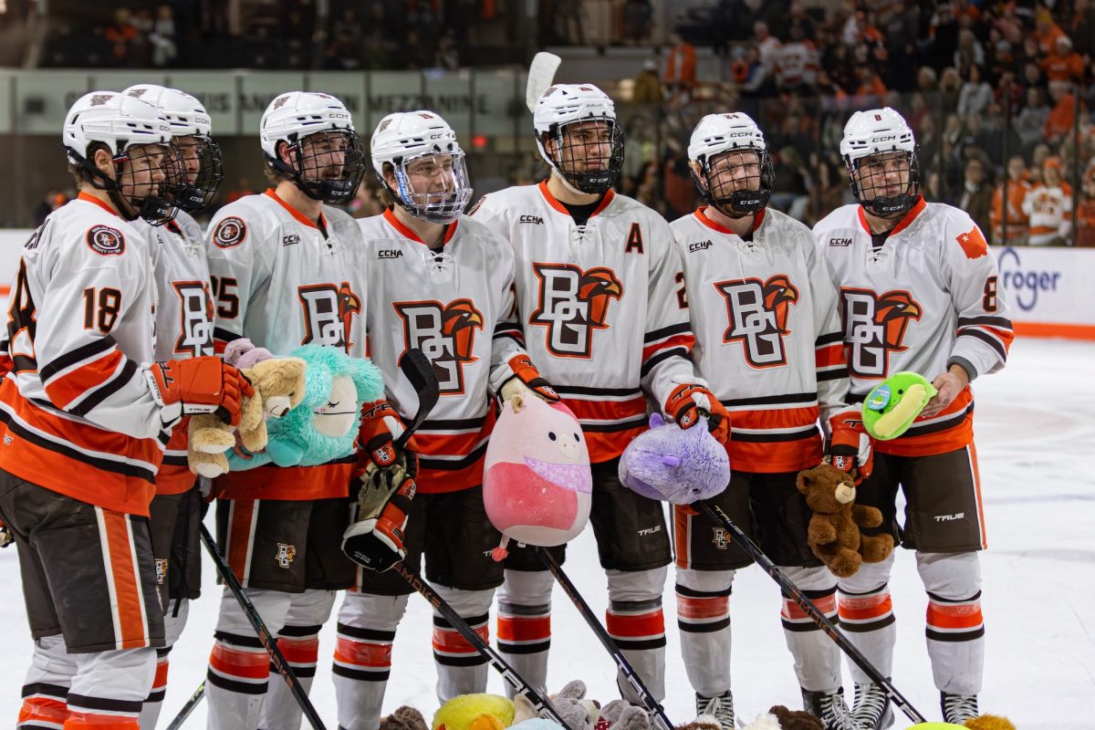 Bowling Green, OH - The Falcons show appreciation for the Teddy Bear Toss donations during a game between the Bowling Green Falcons and the Saint Thomas Tommies at the Slater Family Ice Arena in Bowling Green, Ohio.