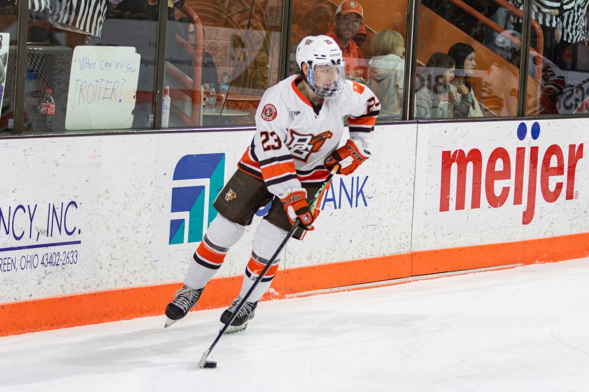 Bowling Green, OH - Falcons junior forward Ben Doran (23) gets the puck behind the goal during a game between the Bowling Green Falcons and the Saint Thomas Tommies at the Slater Family Ice Arena in Bowling Green, Ohio.