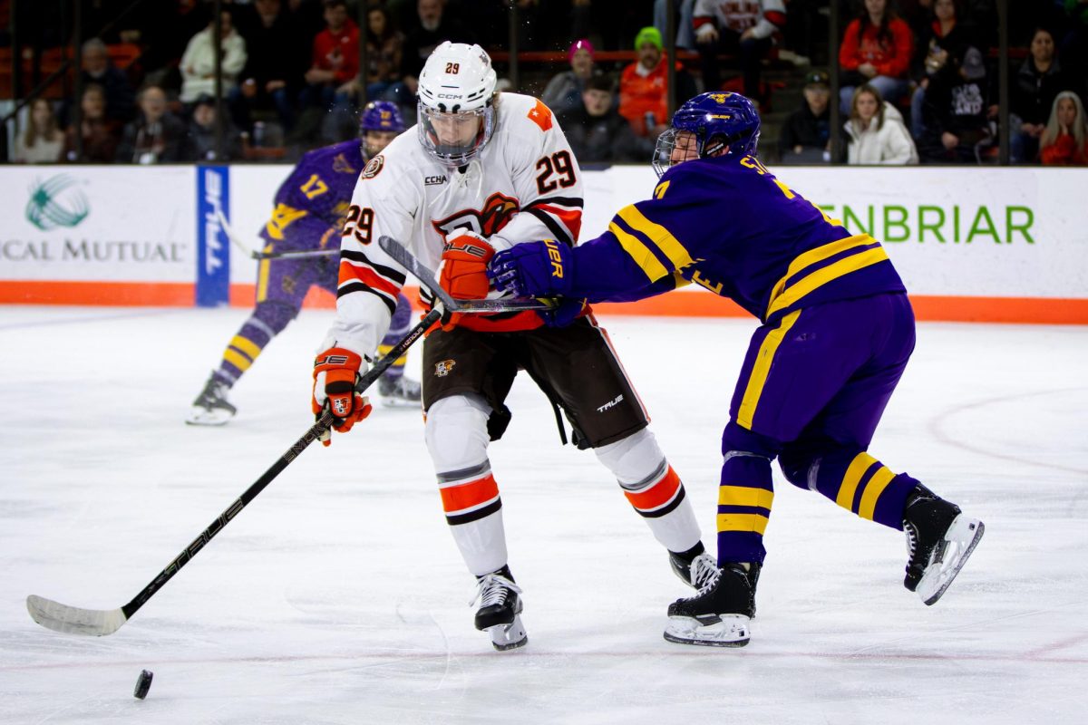 Bowling Green, OH - Mavericks freshman defenseman Bryce Strand (7) shoves Falcons junior forward Brody Waters (29) while going for the puck during a game between the Bowling Green Falcons and the Minnesota State Mavericks at the Slater Family Ice Arena in Bowling Green, Ohio.