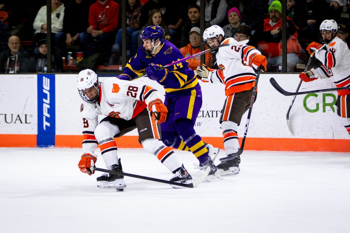 Bowling Green, OH - Falcons senior forward Jaden Grant (28) blocks out Mavericks freshman forward Mason LeBel (14) from getting the puck during a game between the Bowling Green Falcons and the Minnesota State Mavericks at the Slater Family Ice Arena in Bowling Green, Ohio.