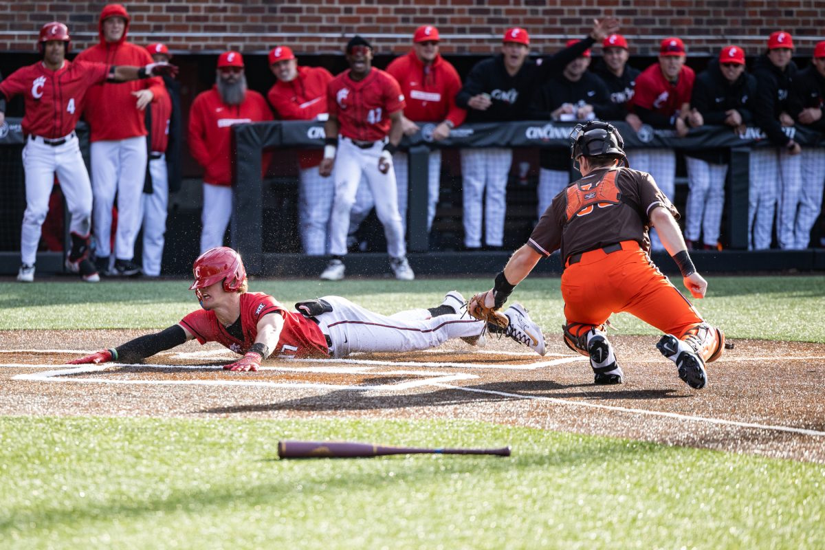 Cincinnati, OH - Bearcats  first baseman  Ryan Tyranski (17) slides past a tag by Falcons senior catcher Cooper McKenzie (38) during a game between the Bowling Green Falcons and the Cincinnati Bearcats at UC Baseball Stadium in Cincinnati, Ohio.