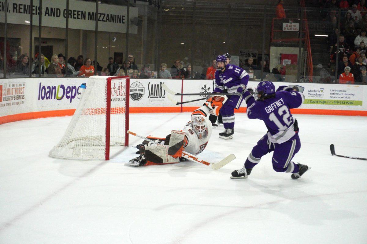 Bowling Green, OH - Falcons freshman goaltender Jacob Steinman stretches for a save during a game against the St. Thomas Tommies at the Slater Family Ice Arena in Bowling Green, Ohio.