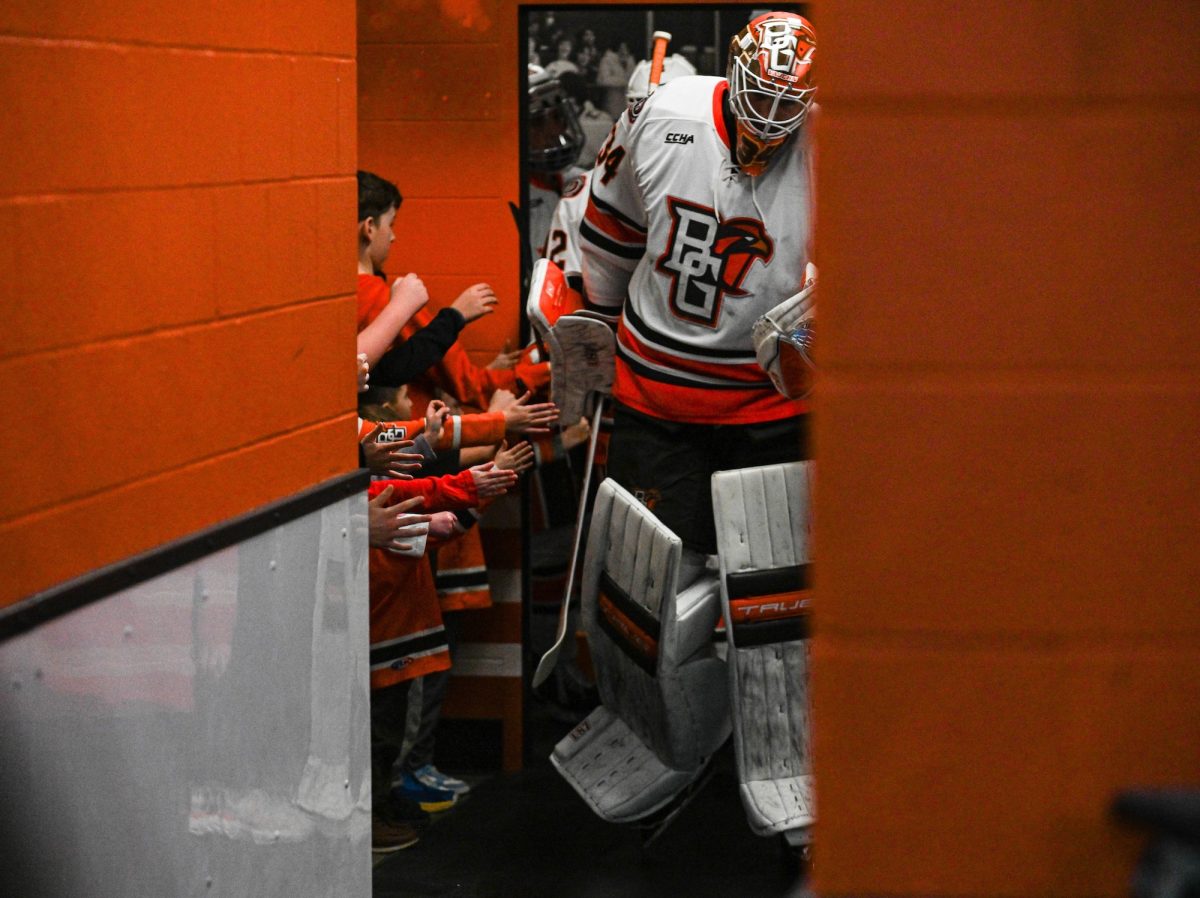 Bowling Green, OH - Falcons junior goalie Cole Moore (34) coming out of the locker room with hands stretched out from future falcons at the Slater Family Ice Arena in Bowling Green, Ohio.