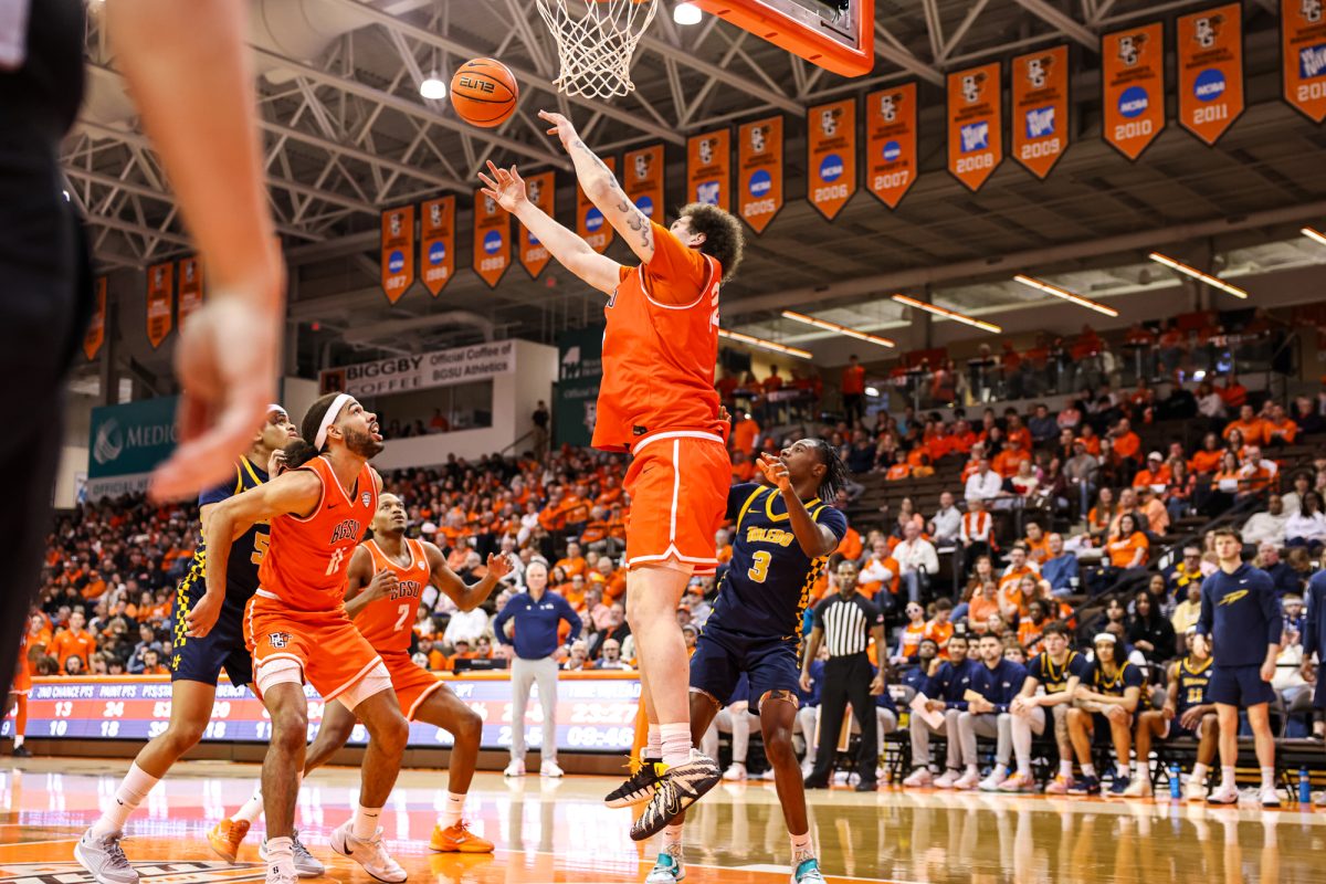 Bowling Green, OH - Falcons junior forward Aiden Goins (34) gets the rebound at the Stroh Center in Bowling Green, Ohio.