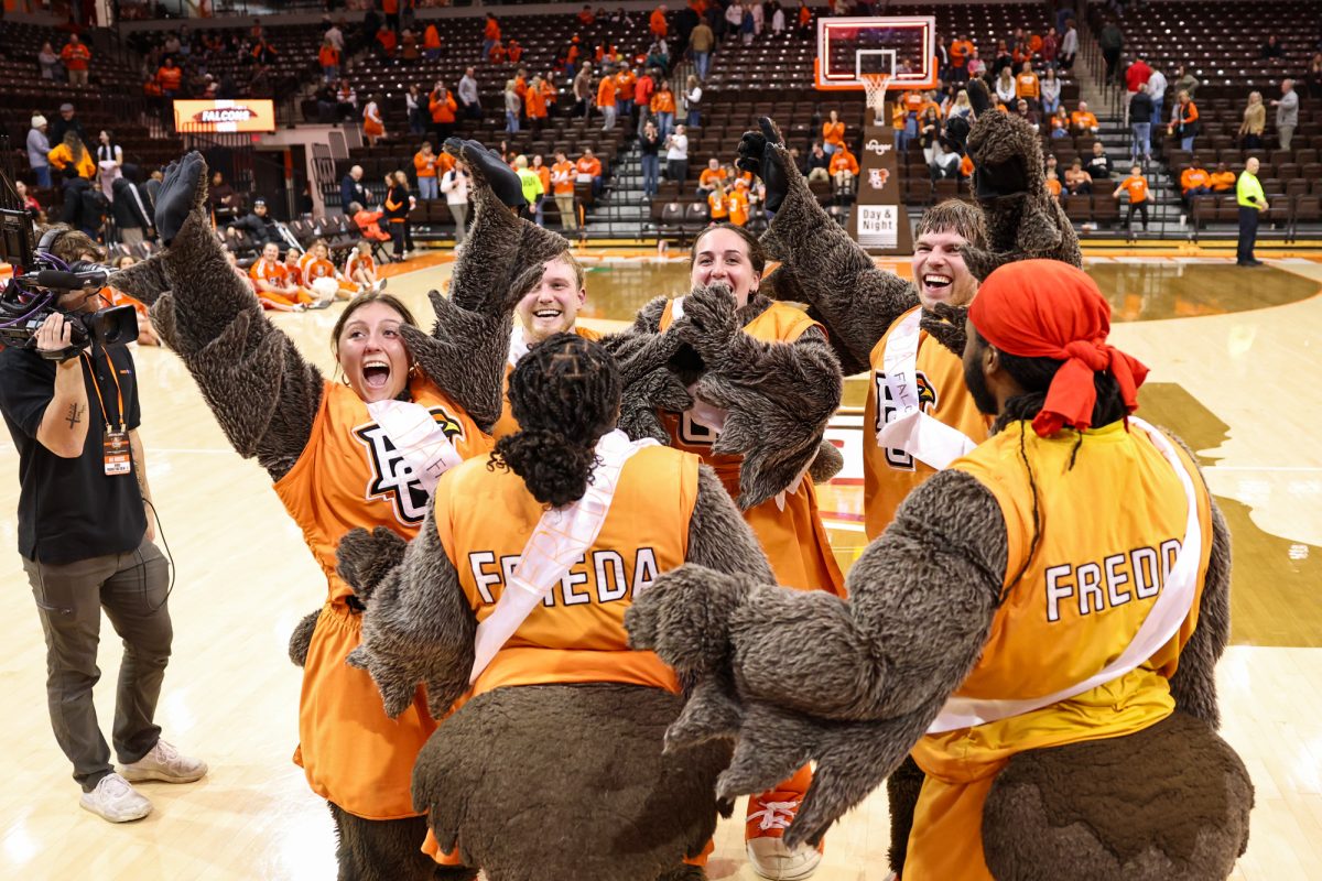 Bowling Green, OH - BGSU student Alex Peete gets mobbed by his brothers after being revealed as Freddie Falcon at the Stroh Center in Bowling Green, Ohio.