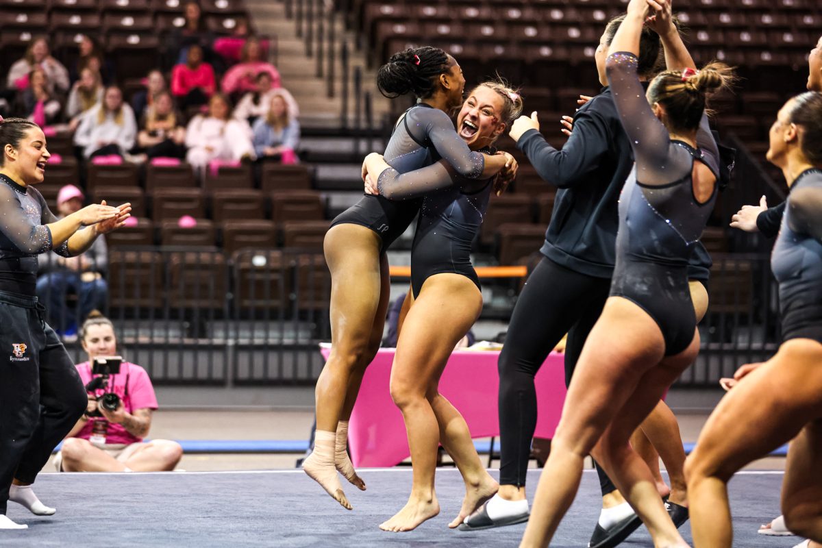 Bowling Green, OH - Falcons sophomore Kayla Shaw celebrates with her team after scoring a 9.900 on her floor routine at the Stroh Center in Bowling Green, Ohio.