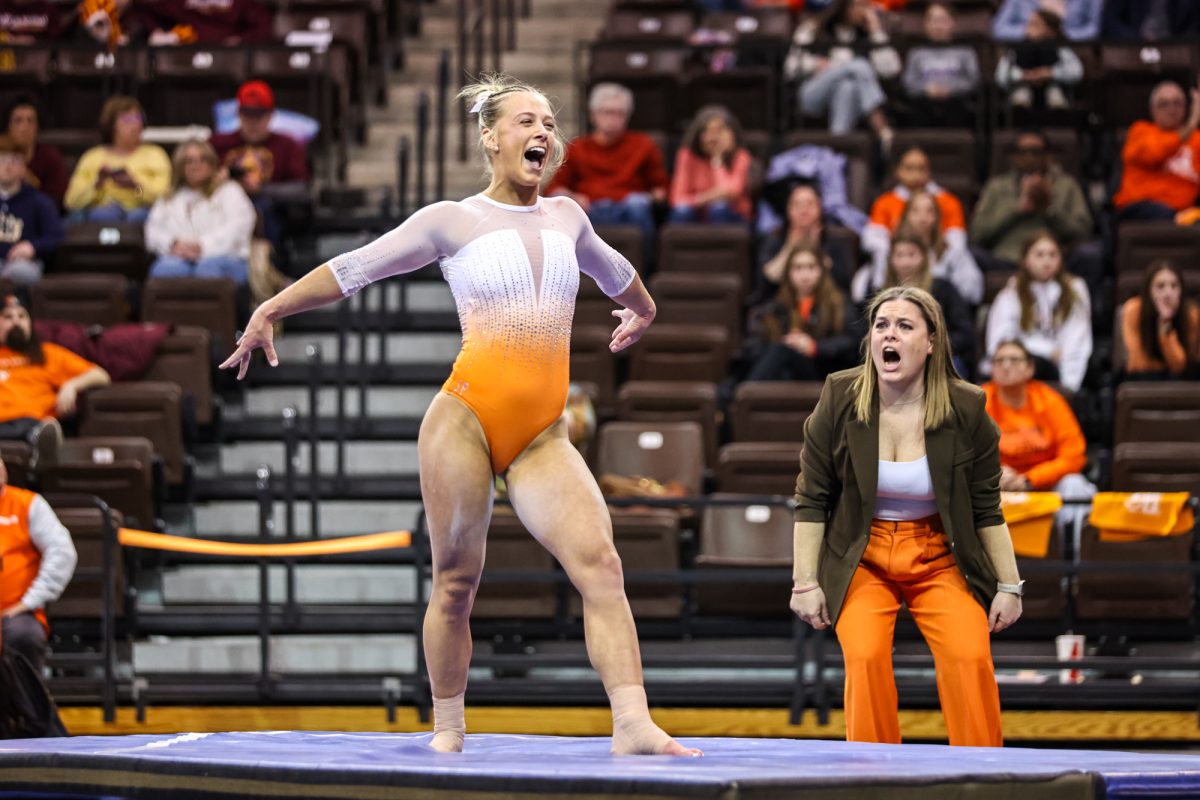 Bowling Green, OH - Falcons senior Madison Coburn celebrates performing a tumbling pass during her floor routine at the Stroh Center in Bowling Green, Ohio.