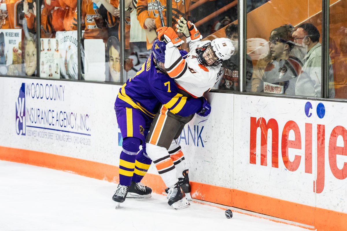 Bowling Green, OH - Mavericks freshman defenseman Bryce Strand (7) lands a check on Falcons freshman forward Jake Sloan (16) during a game between the Minnesota State Mavericks and the Bowling Green Falcons at the Slater Family Ice Arena in Bowling Green, Ohio.