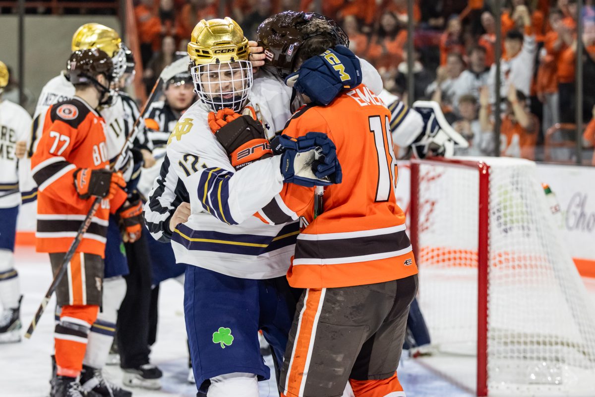 Bowling Green, OH - Fighting Irish sophomore forward Jack Larrigan (18) tangles with Falcons senior forward Quinn Emerson (18) during a game between the Notre Dame Fighting Irish and the Bowling Green Falcons at the Slater Family Ice Arena.