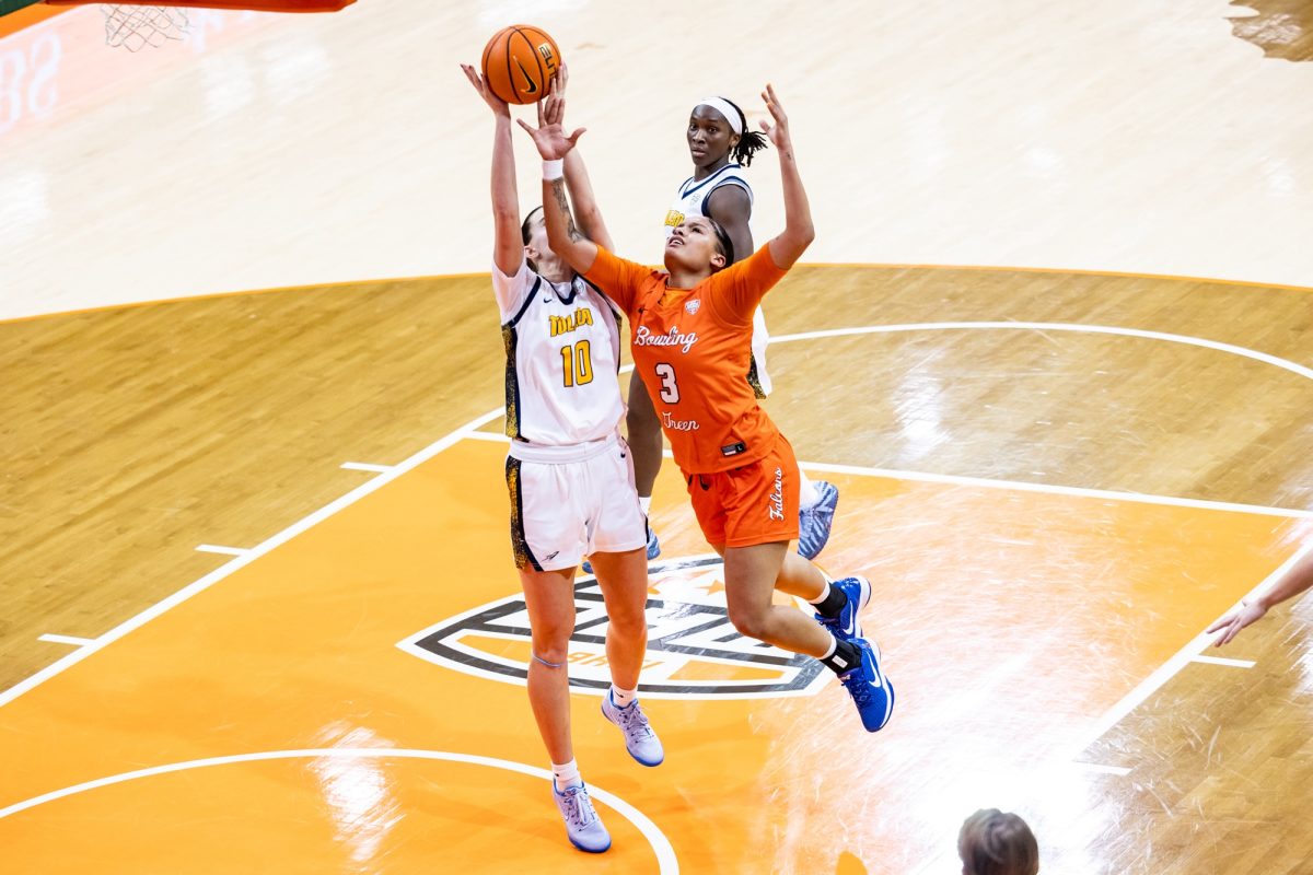 Bowling Green, OH - Falcons sophomore guard John Donahue (3) tangles with Rockets sophomore forward Evalyse Cole (10) during a game between the Toledo Rockets and the Bowling Green Falcons at the Stroh Center in Bowling Green, Ohio.