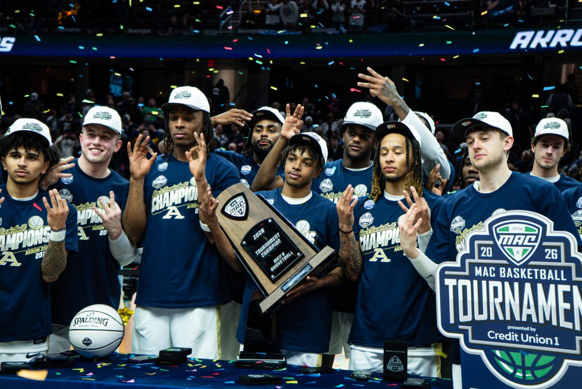 Cleveland, OH - Akron Zips celebrating with the trophy after defeating the Rockets 79-76 during the men’s MAC Basketball Tournament at Rocket Arena in Cleveland, Ohio.