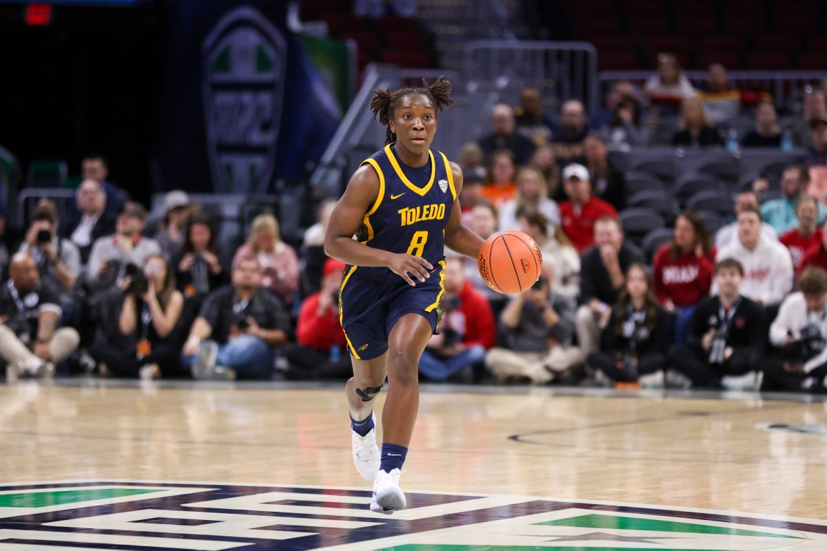 Cleveland, OH - Rockets graduate guard Patricia Anumgba (8) brings the ball down the court during the MAC Championship game at Rocket Arena in Cleveland, Ohio.