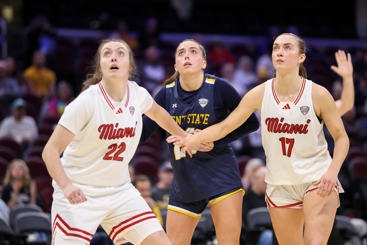 Cleveland, OH - RedHawks senior guard Ashton Elley (22) and RedHawks junior guard Núria Jurjo (17) box out Flashes junior guard Mya Babbitt (23) during the women's MAC Basketball Tournament at Rocket Arena in Cleveland, Ohio.