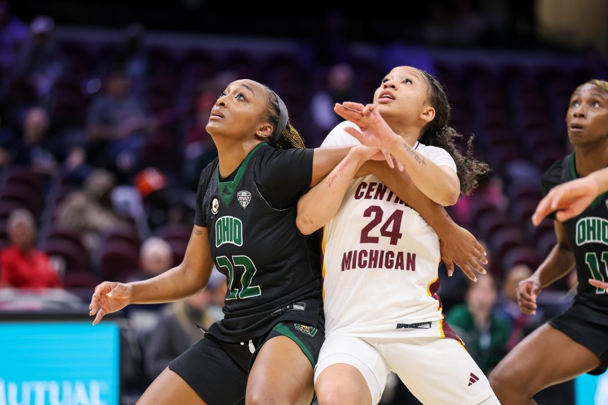Cleveland, OH - Bobcats junior guard Asiah Baxter (22) boxes out Chippewas senior guard Taylor Anderson (24) during the women's MAC Basketball Tournament at Rocket Arena in Cleveland, Ohio.