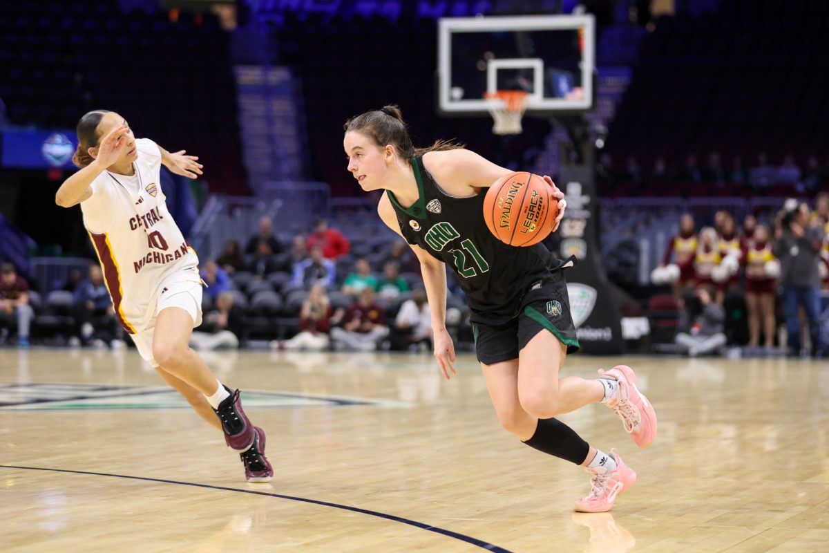 Cleveland, OH - Bobcats junior guard Bailey Tabeling (21) makes a drive to the hoop during the women's MAC Basketball Tournament at Rocket Arena in Cleveland, Ohio.