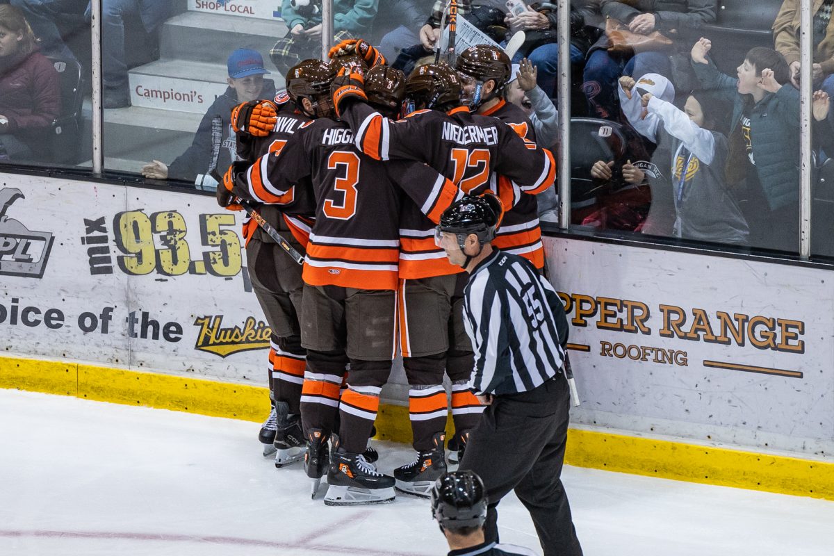 Houghton, MI - The Falcons mob Falcons senior forward Quinn Emerson (18) after scoring a goal during a game between the Bowling Green Falcons and the Michigan Tech Huskies at the John MacInnes Student Ice Arena, in Houghton, Michigan.