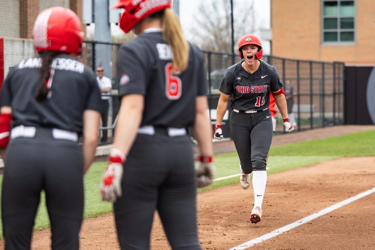 Columbus, OH - Buckeyes junior catcher Emma Tolley (15) screams towards her teammates after hitting a home-run off the scoreboard during a game between the Bowling Green Falcons and the Ohio State Buckeyes at Buckeye Field in Columbus, Ohio.