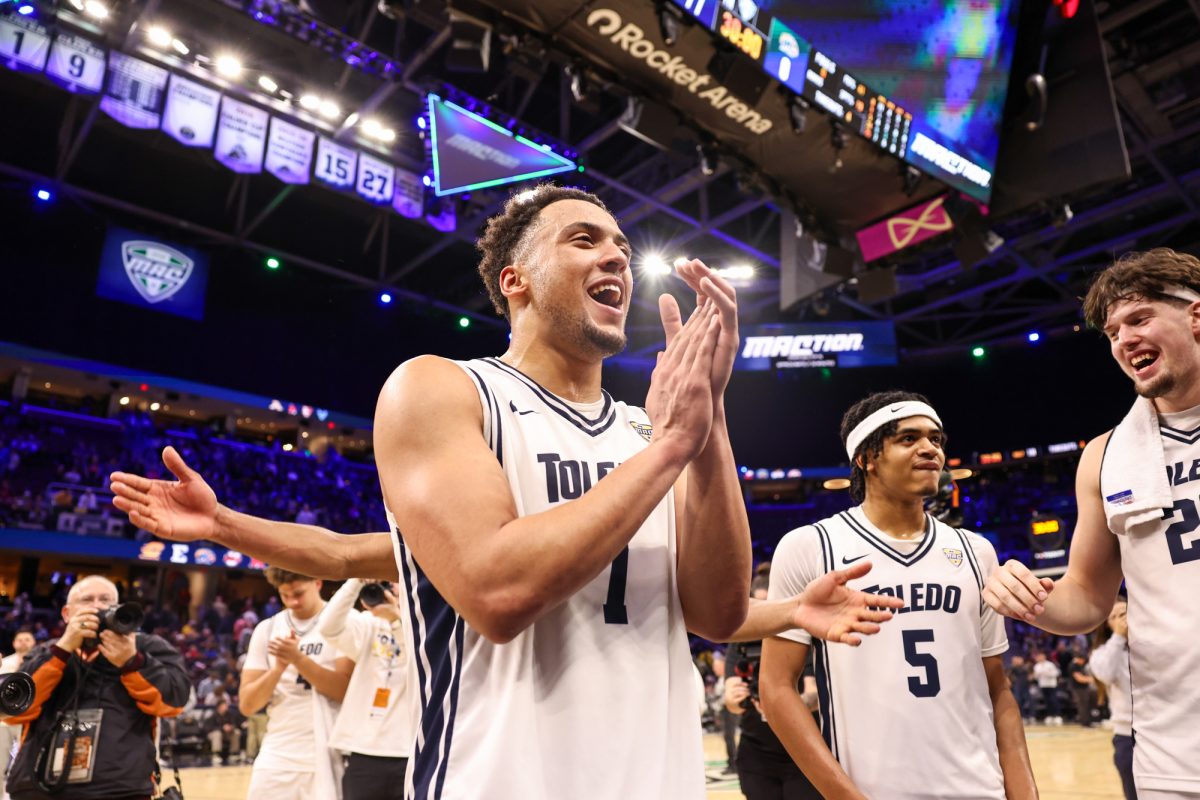 Cleveland, OH - Rockets senior forward Sean Craig (7) celebrates with the Rockets crowd after advancing to the championship game during the men's MAC Basketball Tournament at Rocket Arena in Cleveland, Ohio.