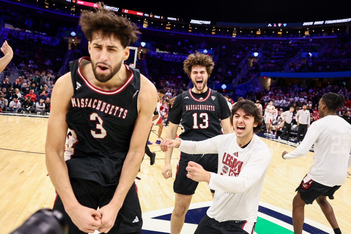 Cleveland, OH - The UMass Minutemen celebrate after defeating the previously undefeated Miami RedHawks during the men's MAC Basketball Tournament at Rocket Arena in Cleveland, Ohio.