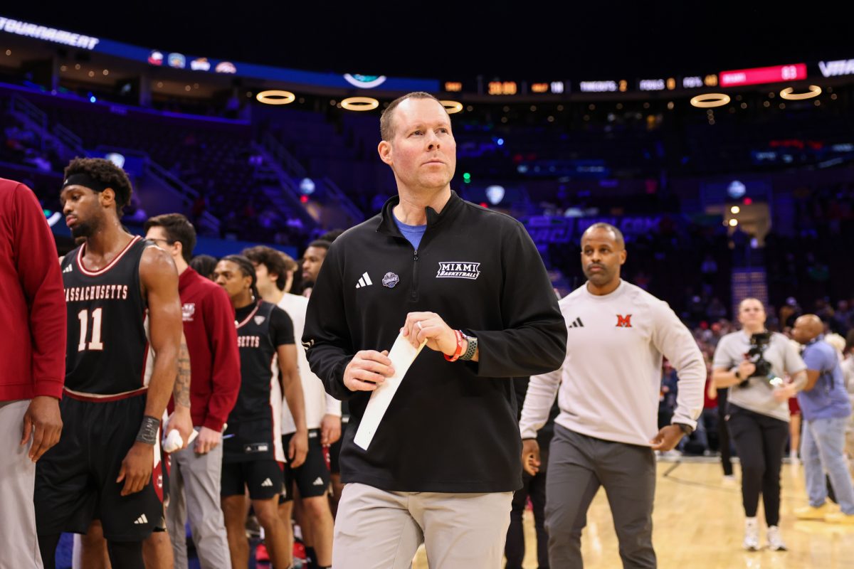 Cleveland, OH - Miami RedHawks head coach Travis Steele looks off into the distance after the UMass Minutemen defeat the RedHawks during the men's MAC Basketball Tournament at Rocket Arena in Cleveland, Ohio.