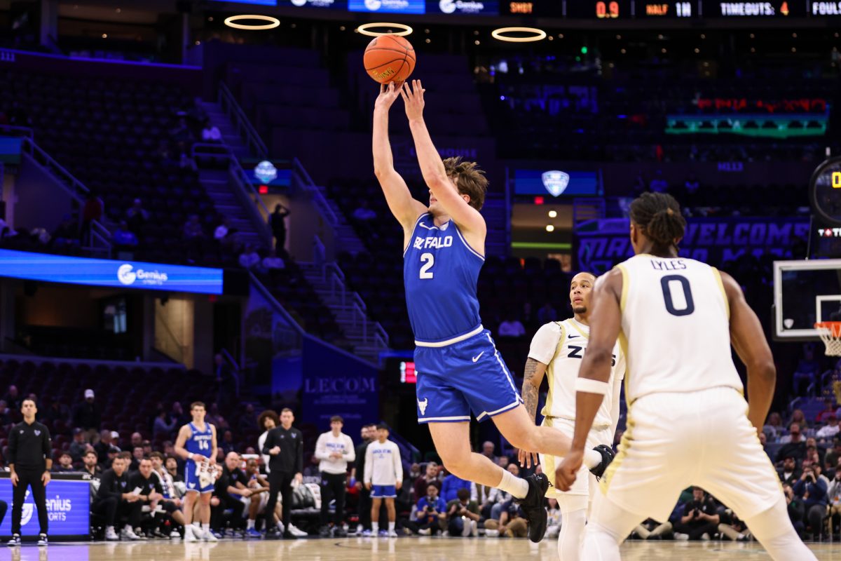 Cleveland, OH - Bulls junior guard Ryan Sabol (2) puts up a buzzer beater shot to close the first period against the Zips during the men's MAC Basketball Tournament at Rocket Arena in Cleveland, Ohio.
