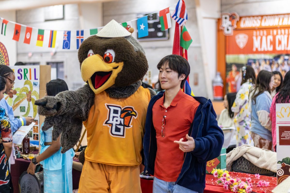 Bowling Green, Ohio - Student takes a picture with Freddy Falcon at the Global Falcon Fest at Perry Field House in Bowling Green, OH.