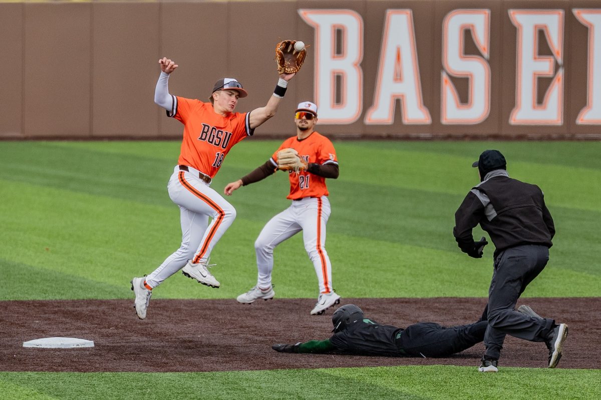 Bowling Green, OH - Falcons freshman infielder Griffin Scheiderer (18) jumps to retrieve a throwdown during a game between the Tiffin Dragons and the Bowling Green Falcons at Stellar Field in Bowling Green, Ohio.