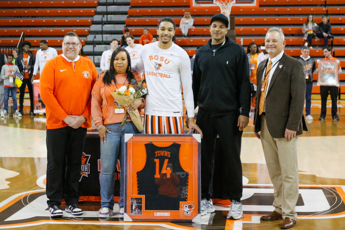 Bowling Green, OH - Sam Towns (middle) celebrates his senior night with his family, head coach Todd Simon (left) and Director of Athletics Derek van der Merwe (right) on March 8, 2024, against Ball State at the Stroh Center.