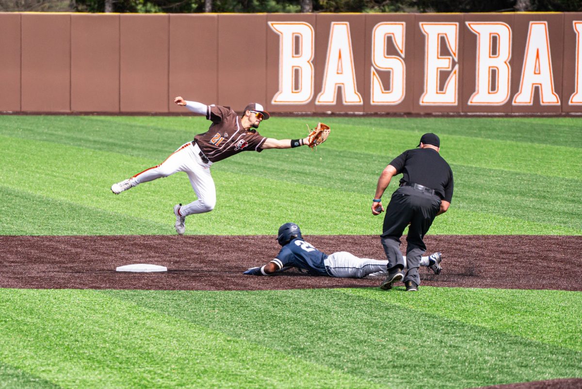 Bowling Green, OH - Falcons senior infielder Sam Seidel (21) making the aerobatic catch during a game between the Akron Zips and the Bowling Green Falcons at Stellar Field in Bowling Green, Ohio.