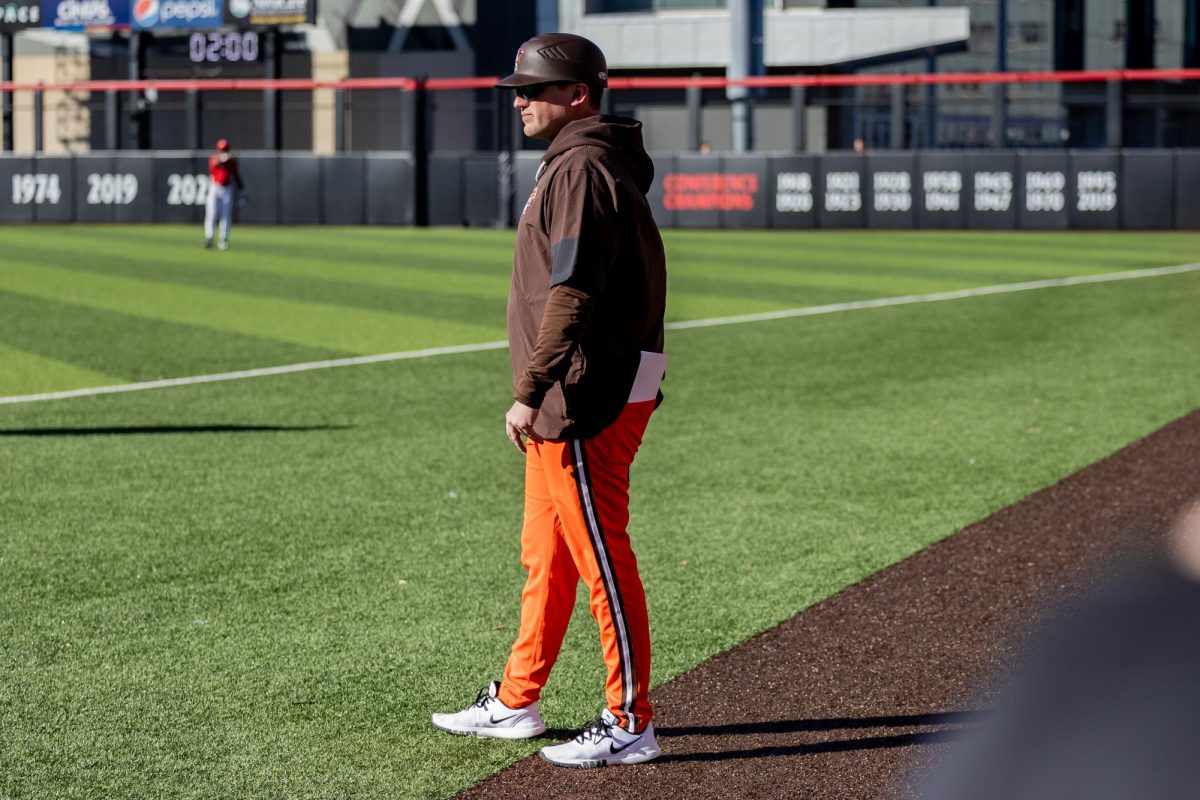 Cincinnati, OH - BGSU baseball recruiting coordinator Jordan Barchus stands by first base in a game against the Cincinnati Bearcats at UC Baseball Stadium in Cincinnati, Ohio, on Feb. 25.