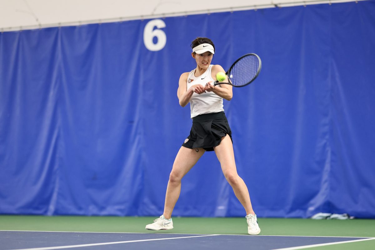 Perrysburg, OH - Falcons junior Qianyu Liu hits the ball during a match against the Bulls at the Perrysburg Tennis Center in Perrysburg, Ohio.